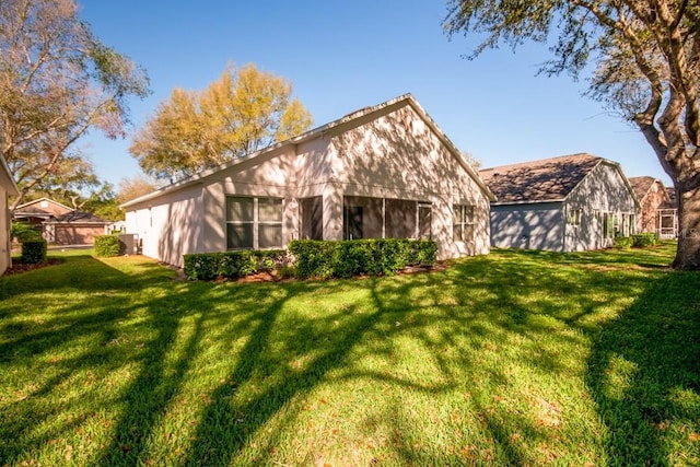 rear view of house featuring a lawn