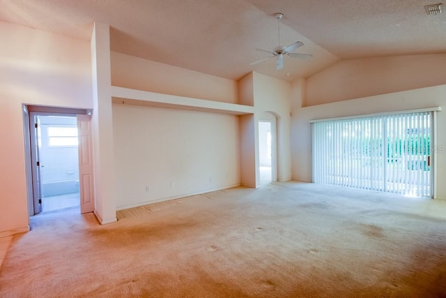 empty room with visible vents, a ceiling fan, carpet, a textured ceiling, and high vaulted ceiling