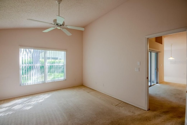 empty room with a ceiling fan, light colored carpet, high vaulted ceiling, and a textured ceiling