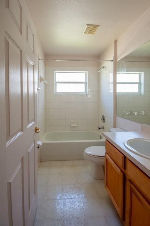 bathroom with toilet, tub / shower combination, vanity, and visible vents