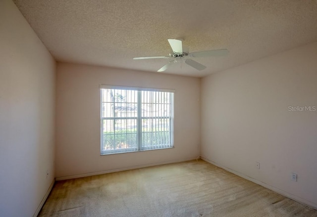 spare room with ceiling fan and a textured ceiling