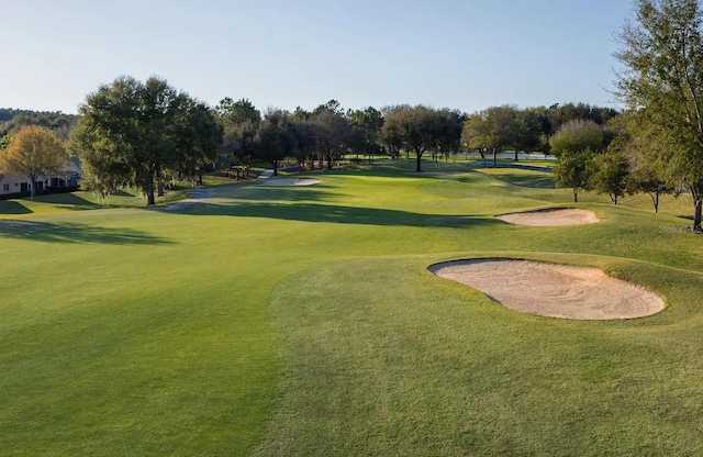 view of property's community featuring a yard and golf course view