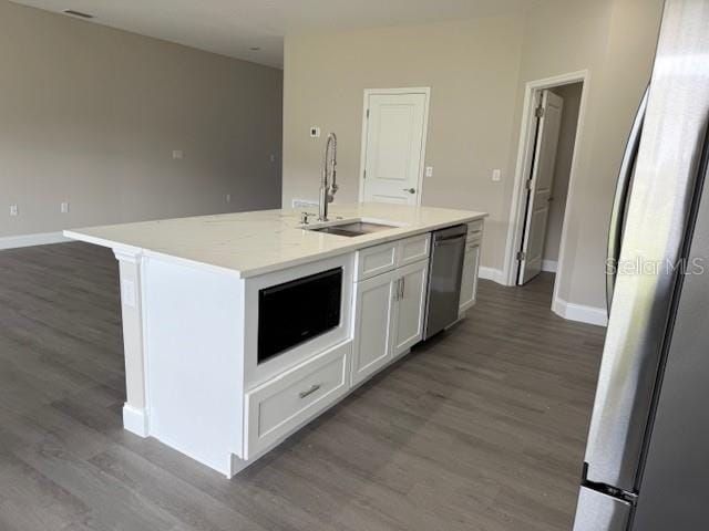 kitchen featuring a sink, appliances with stainless steel finishes, and wood finished floors