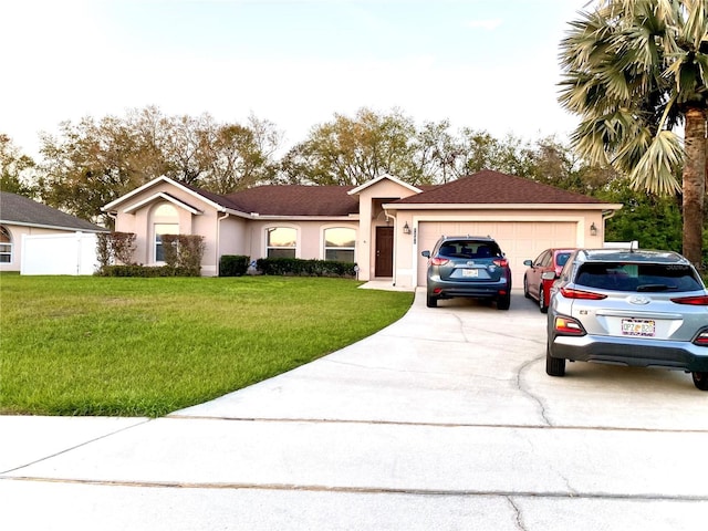 single story home featuring a garage, fence, driveway, stucco siding, and a front lawn