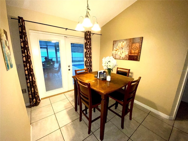 dining room with vaulted ceiling, french doors, light tile patterned floors, and baseboards