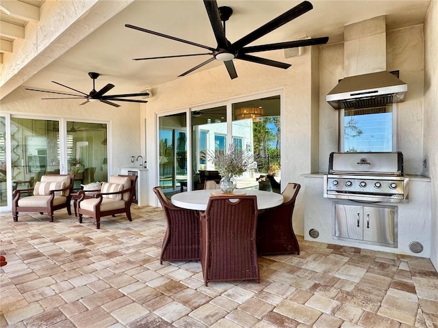 view of patio with outdoor dining space, area for grilling, a ceiling fan, and grilling area