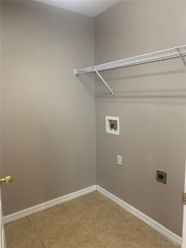 laundry room featuring baseboards, washer hookup, light tile patterned floors, laundry area, and electric dryer hookup