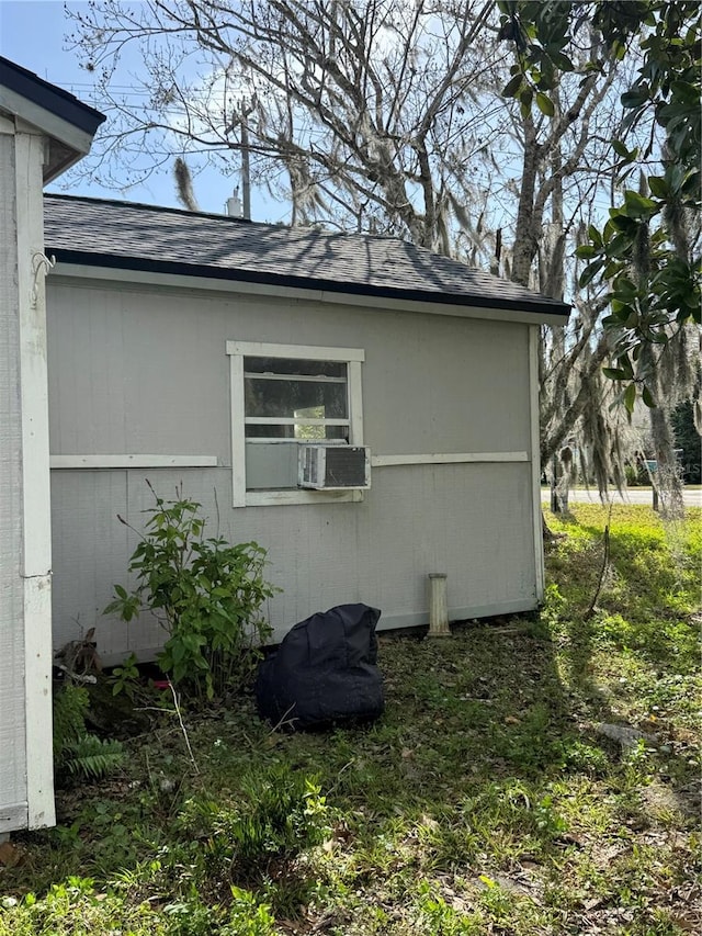 view of side of home featuring a shingled roof