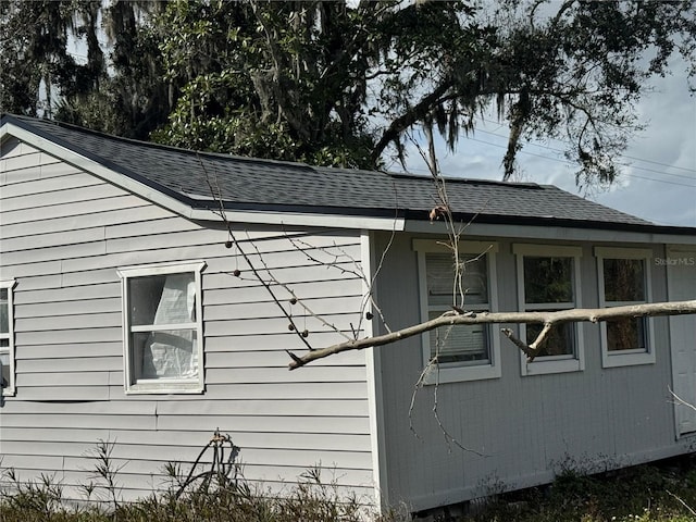 view of property exterior featuring roof with shingles