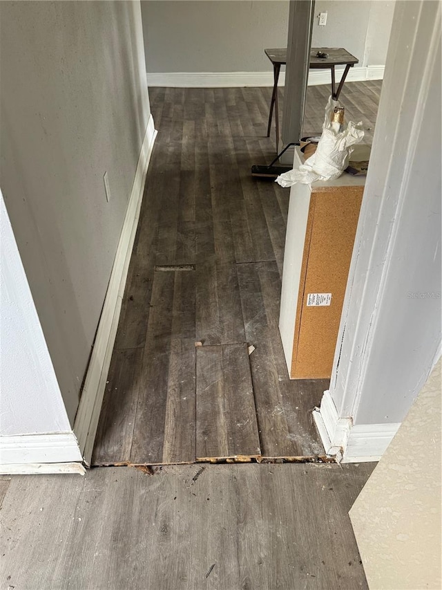 interior details featuring wood finished floors and baseboards