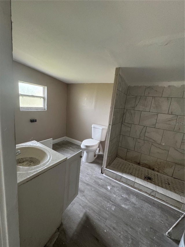 full bathroom featuring a shower stall, toilet, vanity, and baseboards