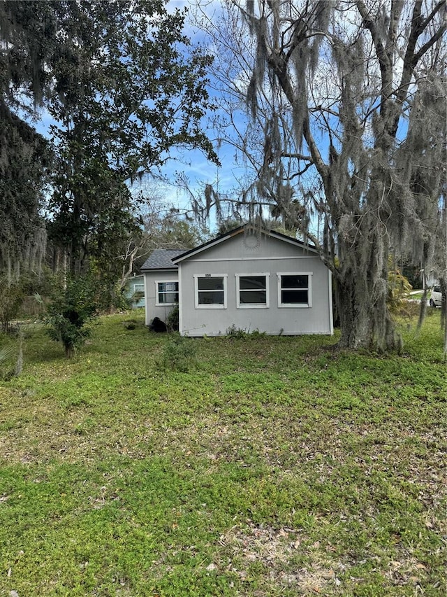 view of side of home with a lawn