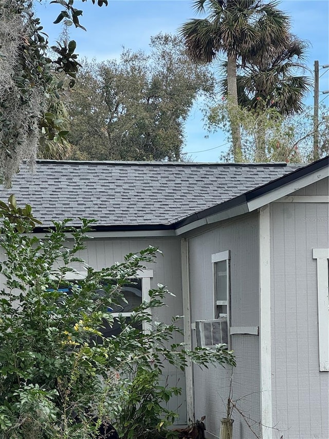 view of property exterior with a shingled roof