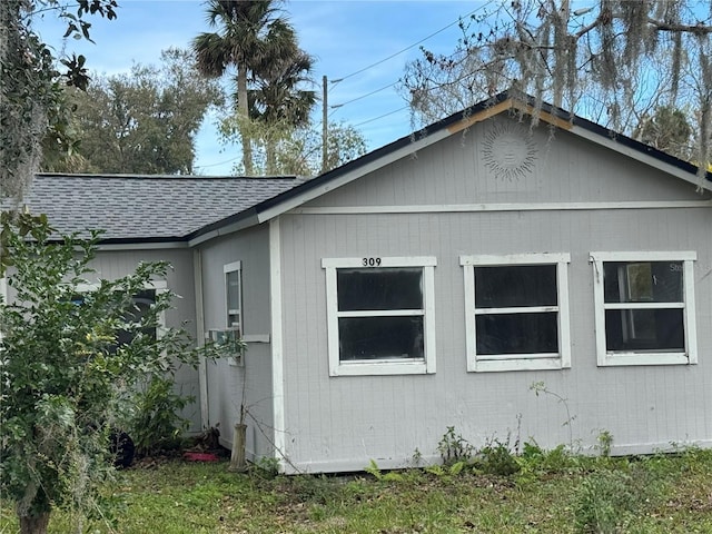 view of home's exterior with a shingled roof