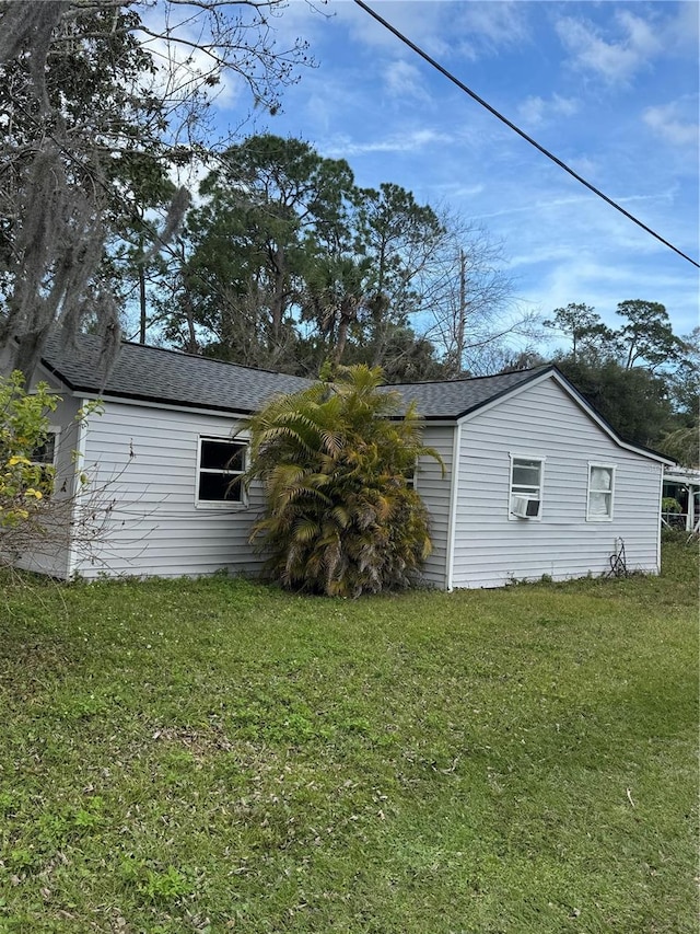 view of property exterior featuring cooling unit and a lawn