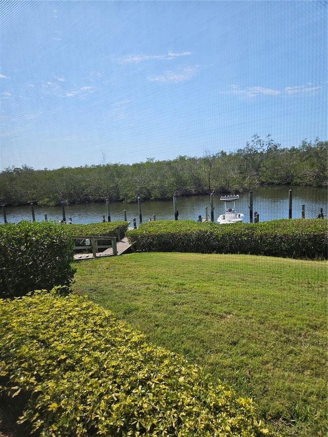 8744 54th Ave W Unit 8744, Bradenton, FL 34210 - view of green lawn featuring a dock and a water view