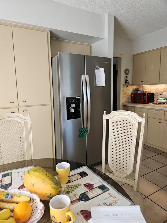 8744 54th Ave W Unit 8744, Bradenton, FL 34210 - kitchen featuring stainless steel fridge, cream cabinetry, backsplash, a textured ceiling, and light countertops