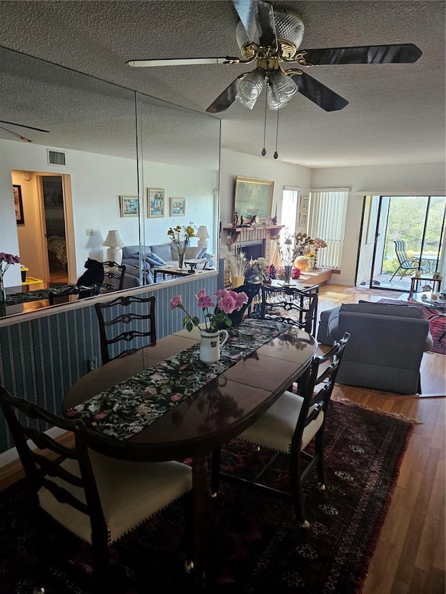 8744 54th Ave W Unit 8744, Bradenton, FL 34210 - dining room with wood finished floors, a textured ceiling, and a ceiling fan