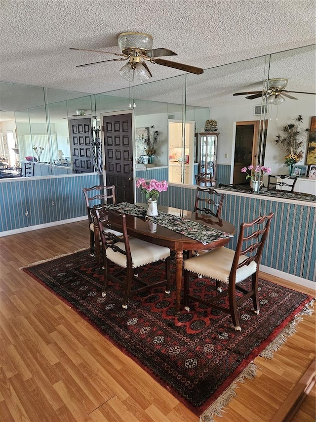 8744 54th Ave W Unit 8744, Bradenton, FL 34210 - dining space with ceiling fan, wood finished floors, a textured ceiling, and baseboards