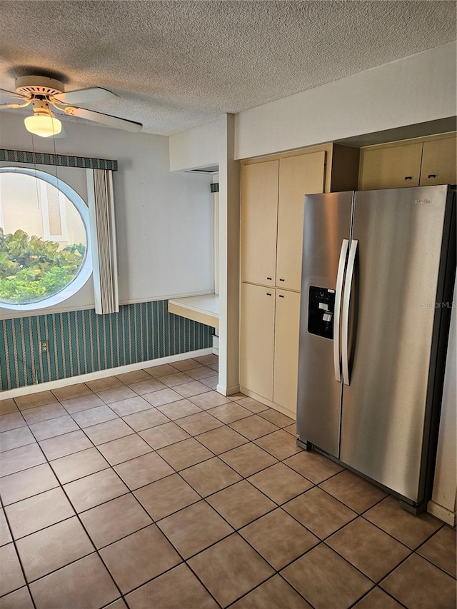 8744 54th Ave W Unit 8744, Bradenton, FL 34210 - kitchen featuring stainless steel refrigerator with ice dispenser, ceiling fan, a textured ceiling, cream cabinets, and light tile patterned flooring