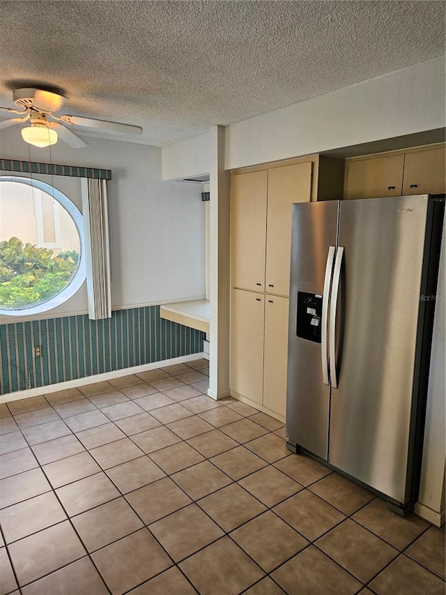 8744 54th Ave W Unit 8744, Bradenton, FL 34210 - kitchen with stainless steel fridge with ice dispenser, cream cabinets, a textured ceiling, ceiling fan, and light tile patterned floors