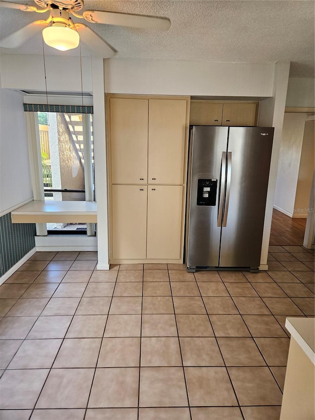 8744 54th Ave W Unit 8744, Bradenton, FL 34210 - kitchen featuring stainless steel fridge, cream cabinets, a ceiling fan, light tile patterned floors, and a textured ceiling