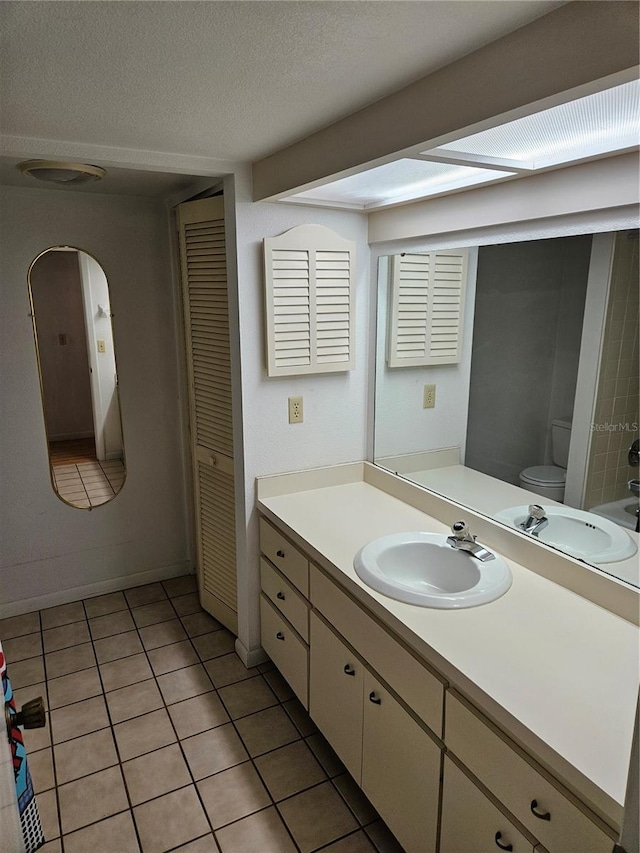 8744 54th Ave W Unit 8744, Bradenton, FL 34210 - bathroom featuring vanity, tile patterned floors, toilet, and a textured ceiling