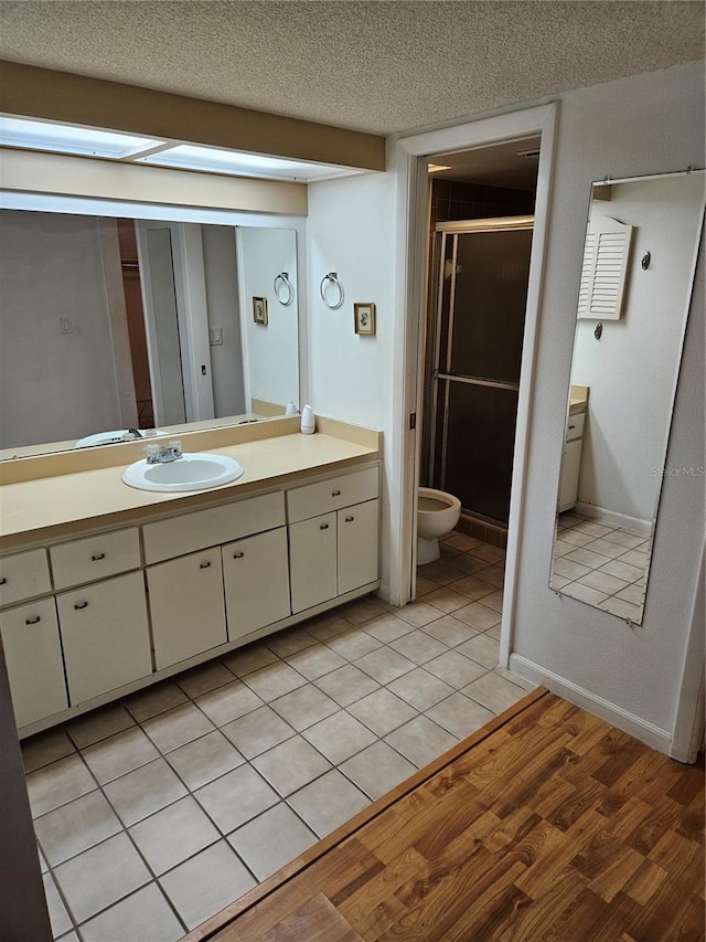 8744 54th Ave W Unit 8744, Bradenton, FL 34210 - full bath featuring a shower stall, a textured ceiling, vanity, and baseboards