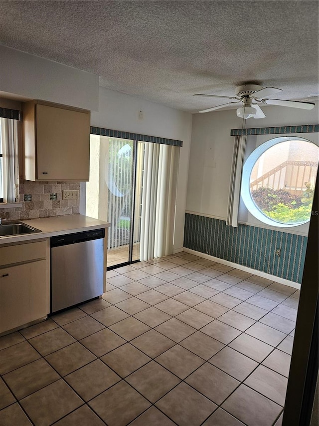 8744 54th Ave W Unit 8744, Bradenton, FL 34210 - kitchen featuring stainless steel dishwasher, a ceiling fan, light countertops, backsplash, and a sink