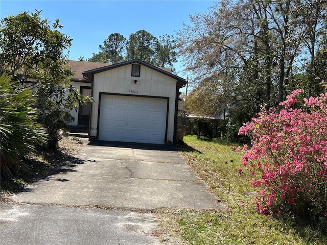 garage featuring concrete driveway