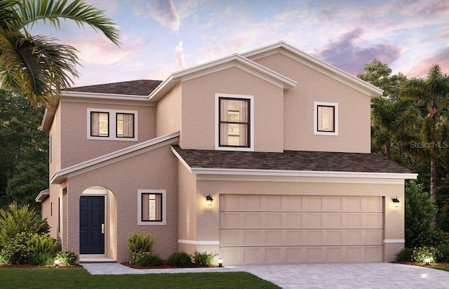 view of front of home featuring stucco siding, driveway, and an attached garage