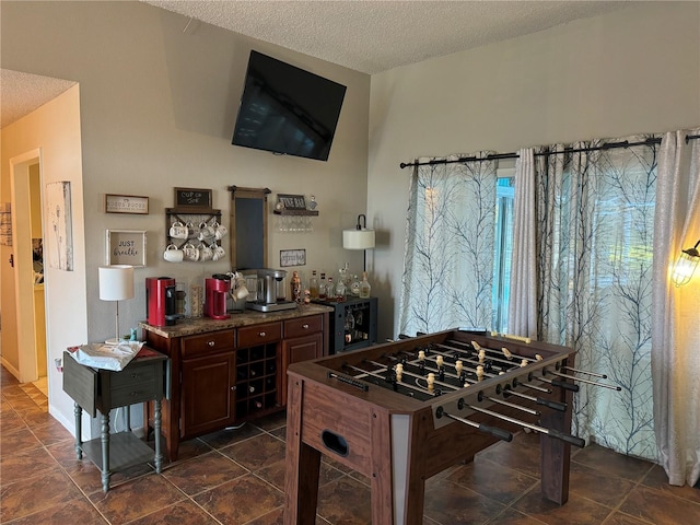 kitchen featuring a textured ceiling and dark countertops