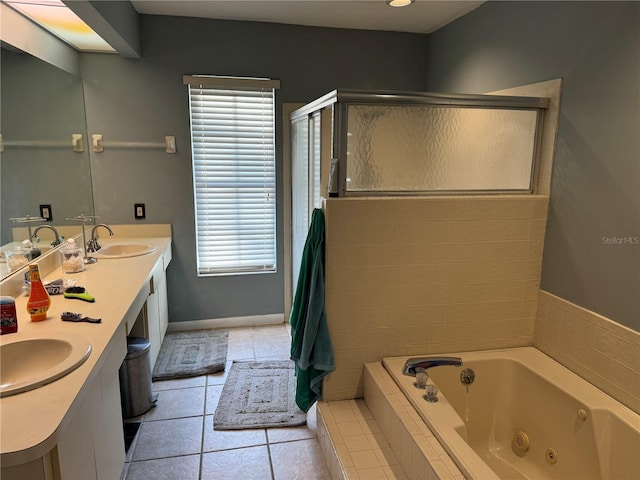 bathroom featuring tile patterned floors, a whirlpool tub, a shower stall, and a sink