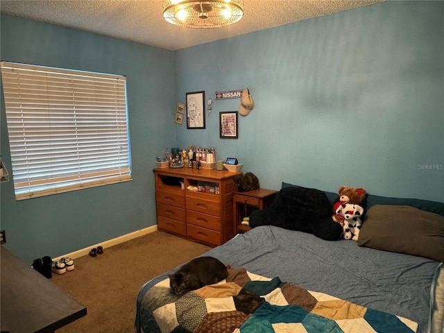 carpeted bedroom featuring an inviting chandelier, a textured ceiling, and baseboards