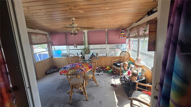 sunroom featuring wood ceiling and a ceiling fan