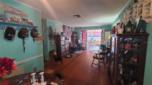 interior space featuring visible vents, crown molding, and wood finished floors