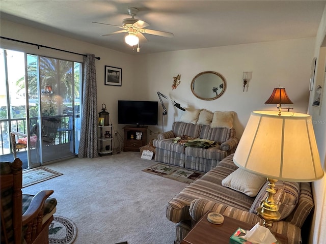 carpeted living room featuring a ceiling fan