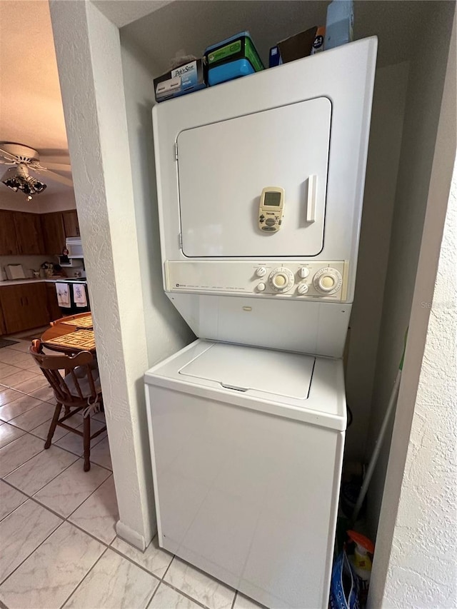 laundry area featuring stacked washer and dryer and laundry area