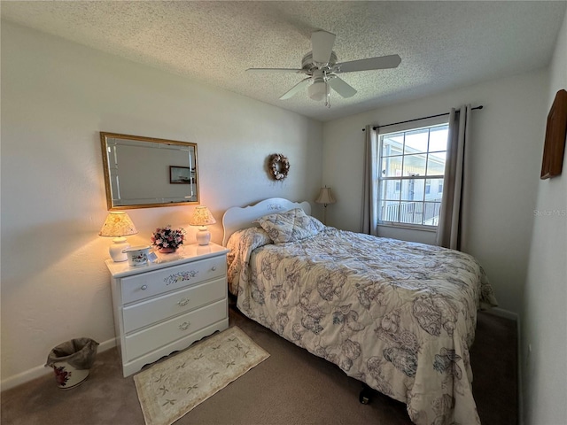 bedroom featuring carpet floors, a textured ceiling, and a ceiling fan
