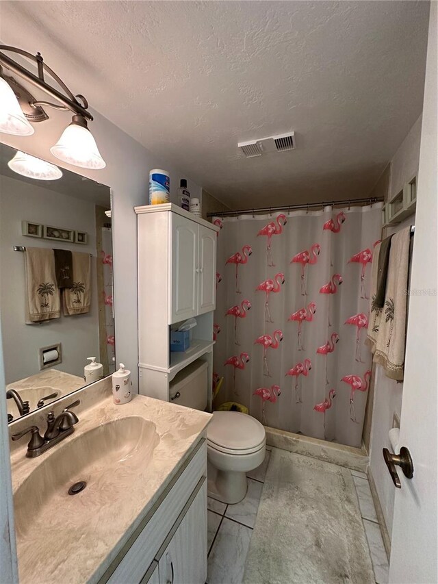 full bath featuring a textured ceiling, visible vents, toilet, and vanity