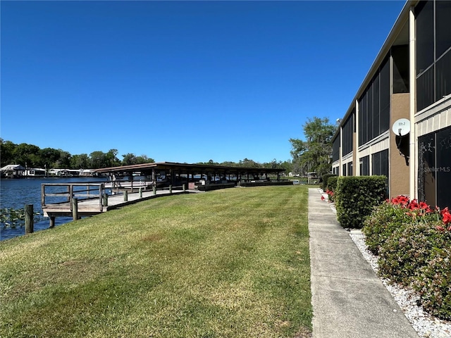 view of yard with a dock and a water view