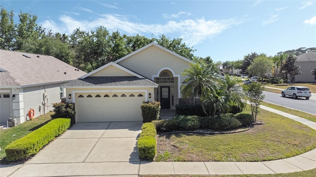 ranch-style house featuring roof with shingles, an attached garage, a front lawn, stucco siding, and concrete driveway