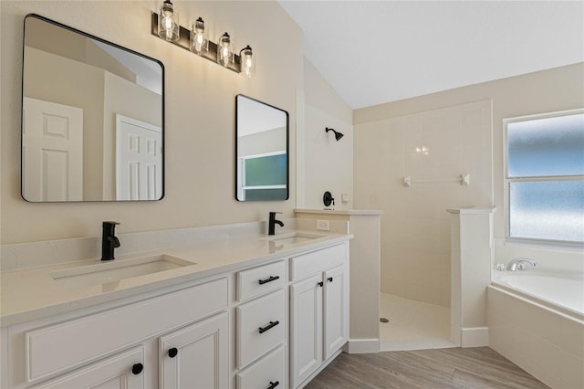 full bathroom featuring double vanity, a sink, walk in shower, and lofted ceiling