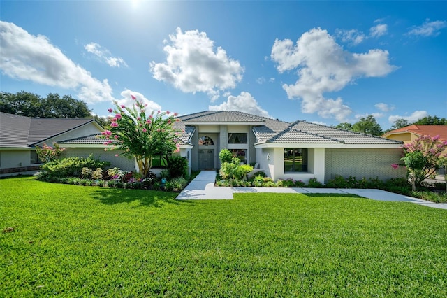 365 N Spaulding Cv, Lake Mary, FL 32746 - mediterranean / spanish-style house with a front yard, stucco siding, and a tiled roof