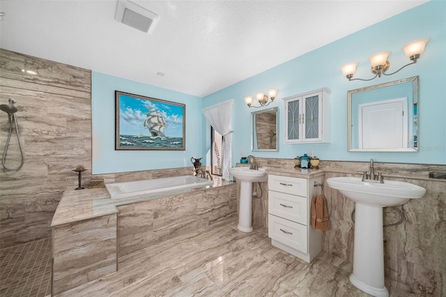 365 N Spaulding Cv, Lake Mary, FL 32746 - full bath featuring marble finish floors, a garden tub, tile walls, wainscoting, and a sink