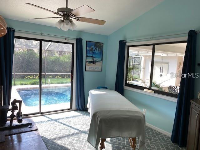 365 N Spaulding Cv, Lake Mary, FL 32746 - carpeted bedroom with access to outside, lofted ceiling, a ceiling fan, and baseboards