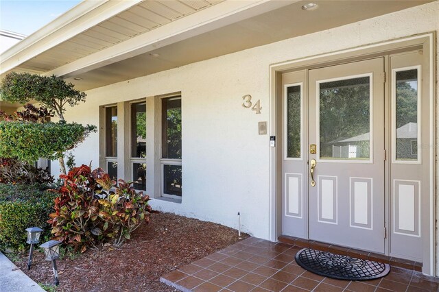 34 Misty Meadow Ln, Mulberry, FL 33860 - doorway to property with stucco siding