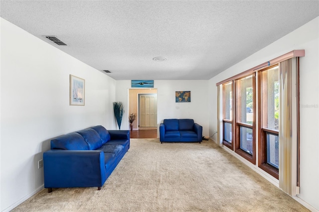 34 Misty Meadow Ln, Mulberry, FL 33860 - sitting room with a textured ceiling, carpet flooring, and visible vents