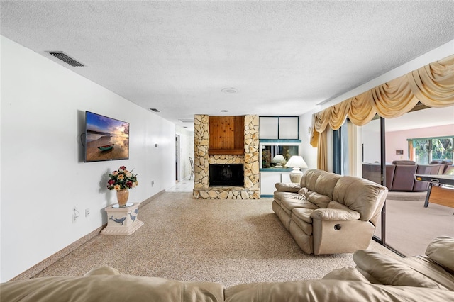 34 Misty Meadow Ln, Mulberry, FL 33860 - living area with a textured ceiling, carpet flooring, a stone fireplace, and visible vents