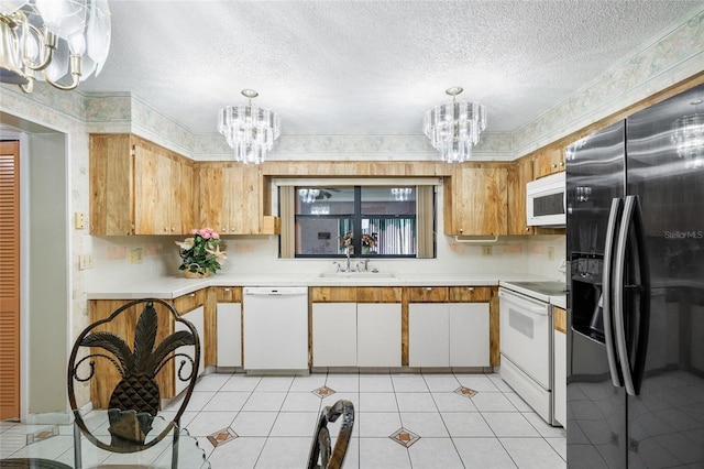 34 Misty Meadow Ln, Mulberry, FL 33860 - kitchen featuring a sink, light countertops, white appliances, and an inviting chandelier
